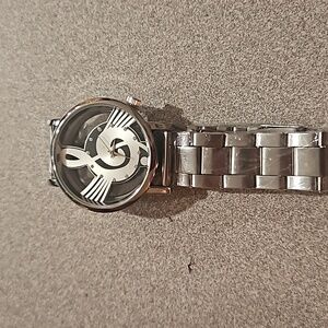 Silver watch music note and see threw face